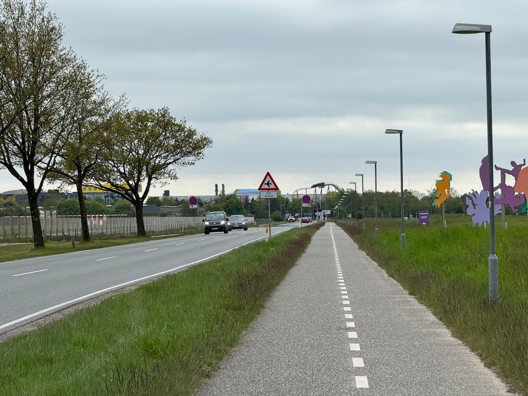 Road and bike path running from airport towards Billund city center with Legoland in the distance