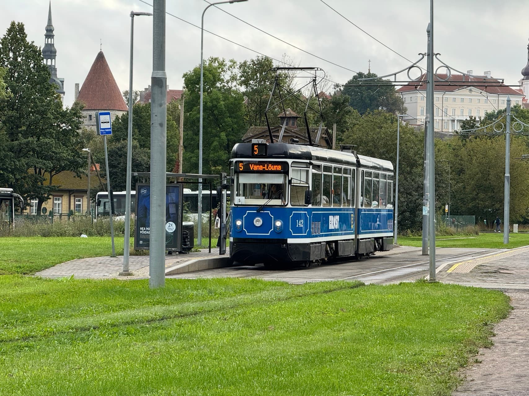 The vintage Tallinn tram glides down a rainy street in Estonia, showcasing the city’s historic transportation